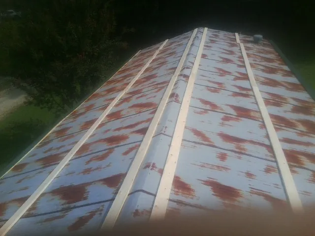 Rusted metal roof panels with new wood purlins before replacement — Storm Damage Roof Repair in Moorestown by Roofing Brothers