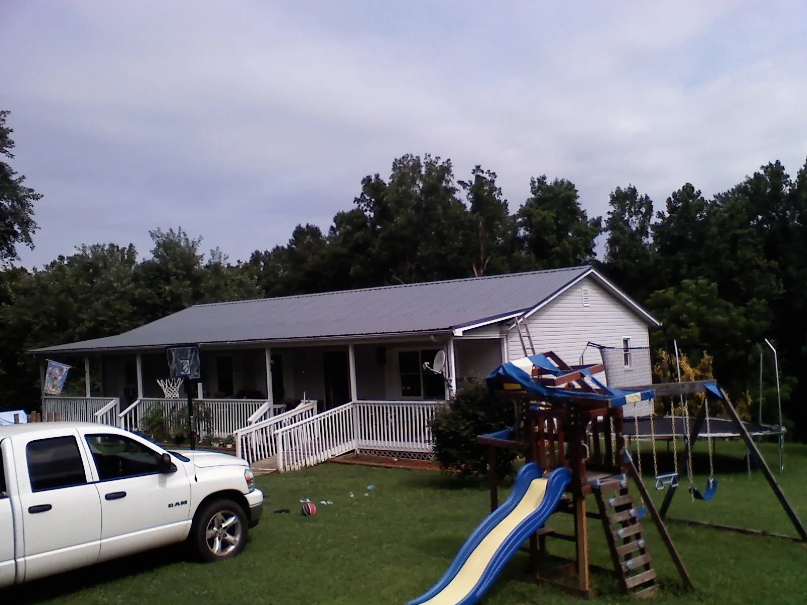 Dark metal roof on a country home with a full length front porch in Moorestown