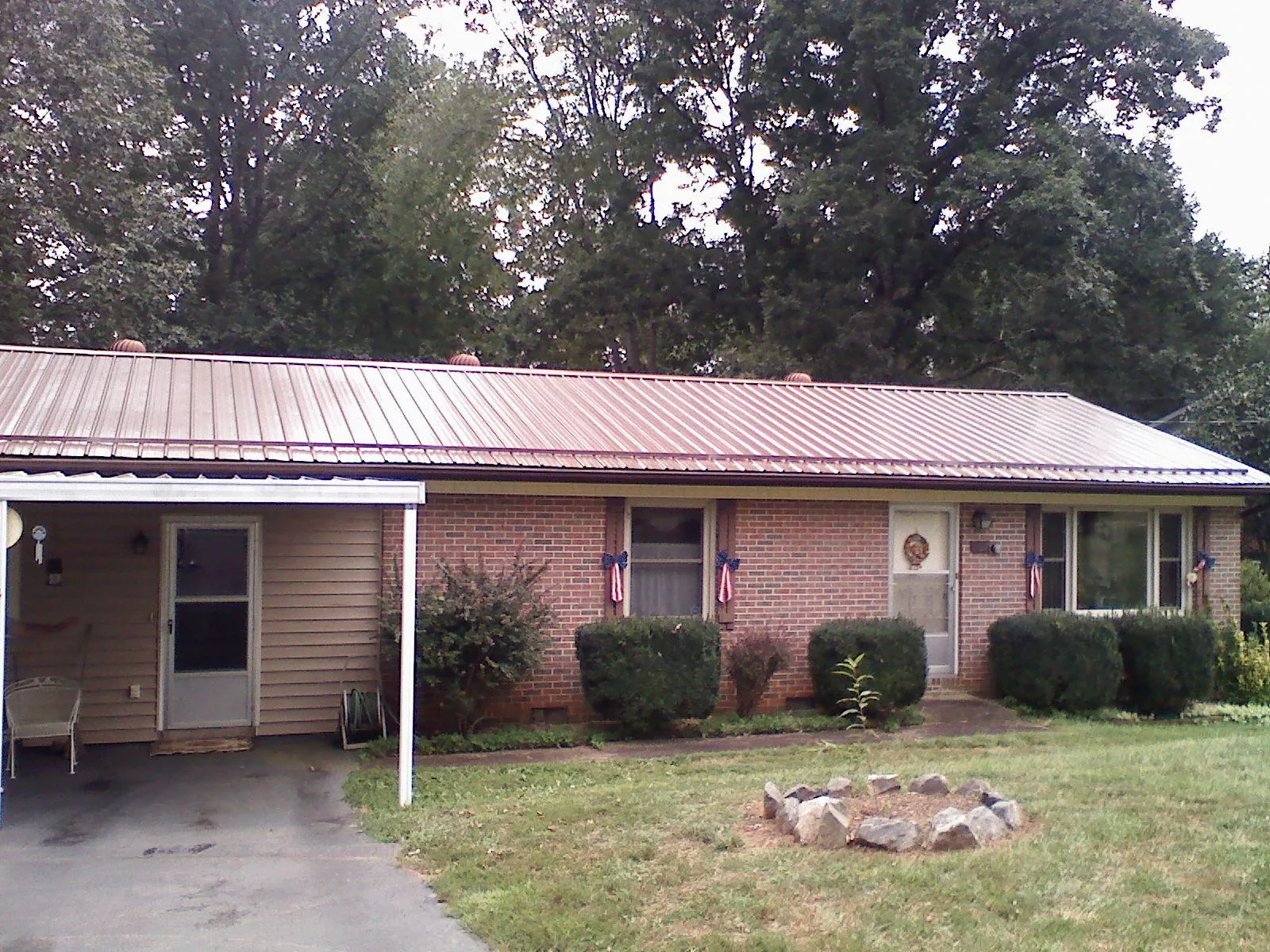 Bronze metal roof and carport on a brick ranch home — Roof Repair work by our crew in Moorestown